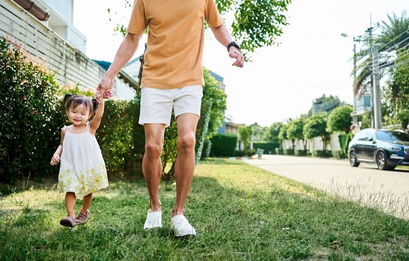 Father holding hand of his daughter