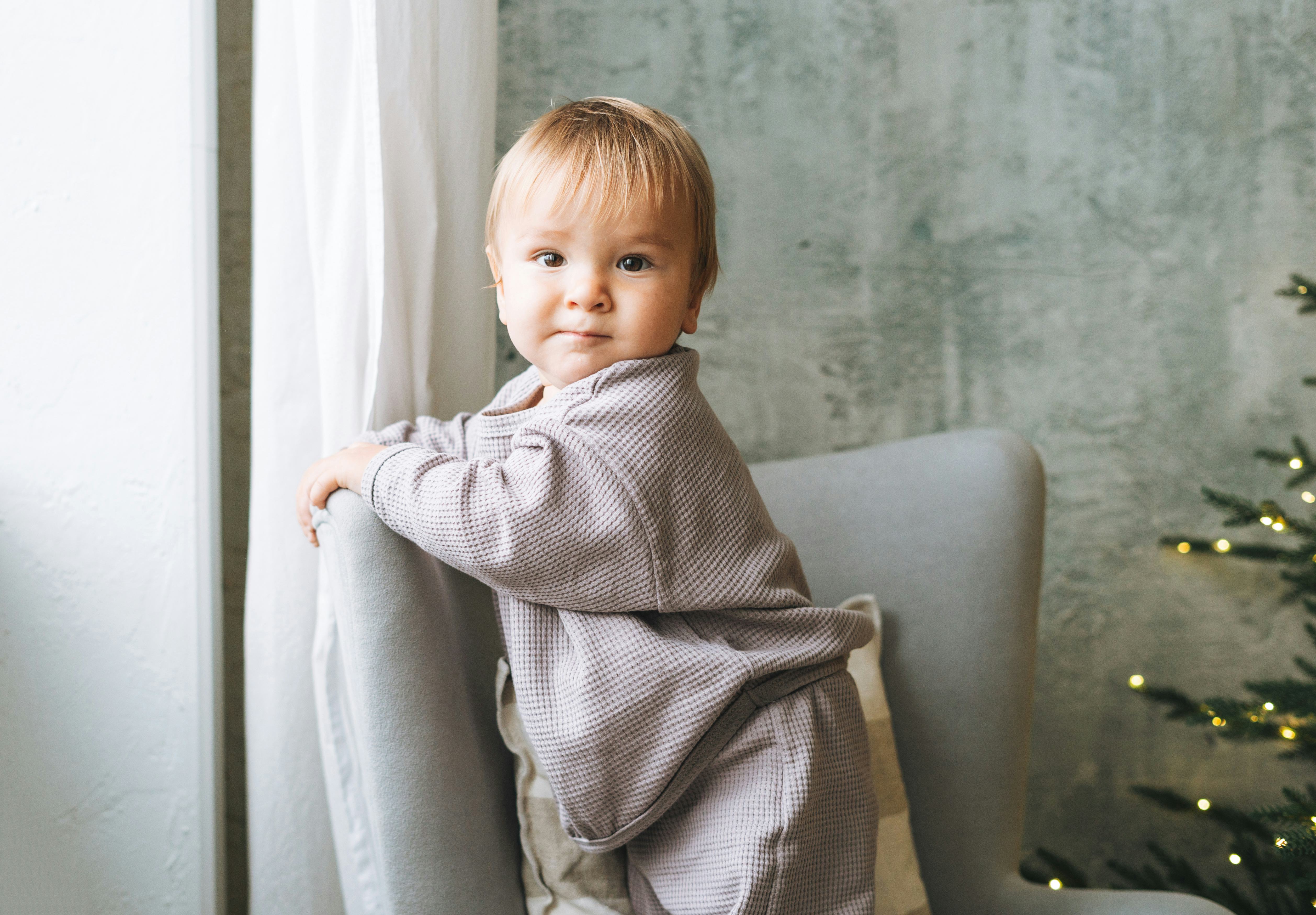 baby boy near the Christmas tree at home