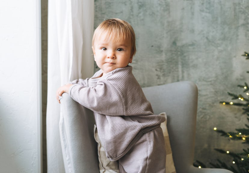 baby boy near the Christmas tree at home