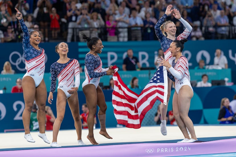 Team USA Gymnastics celebrating winning a gold medal at the Olympics.