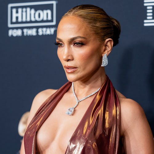 Jennifer Lopez wore a plunging suit to promote her bestie’s debut novel.