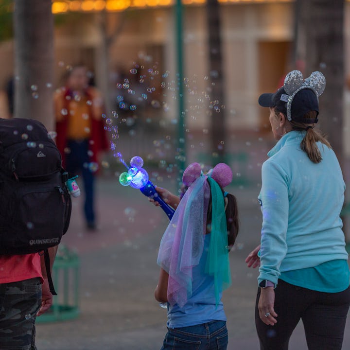 ANAHEIM, CA - FEBRUARY 25: A girl makes bubbles an the entrance to Disneyland Park on February 25, 2...