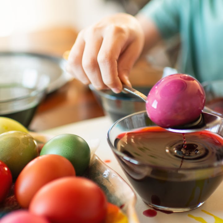 Boy painting Easter eggs