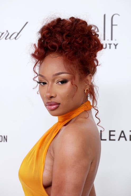 Megan Thee Stallion's "Megchella" workout 'fits include plunging, navel-baring tops.