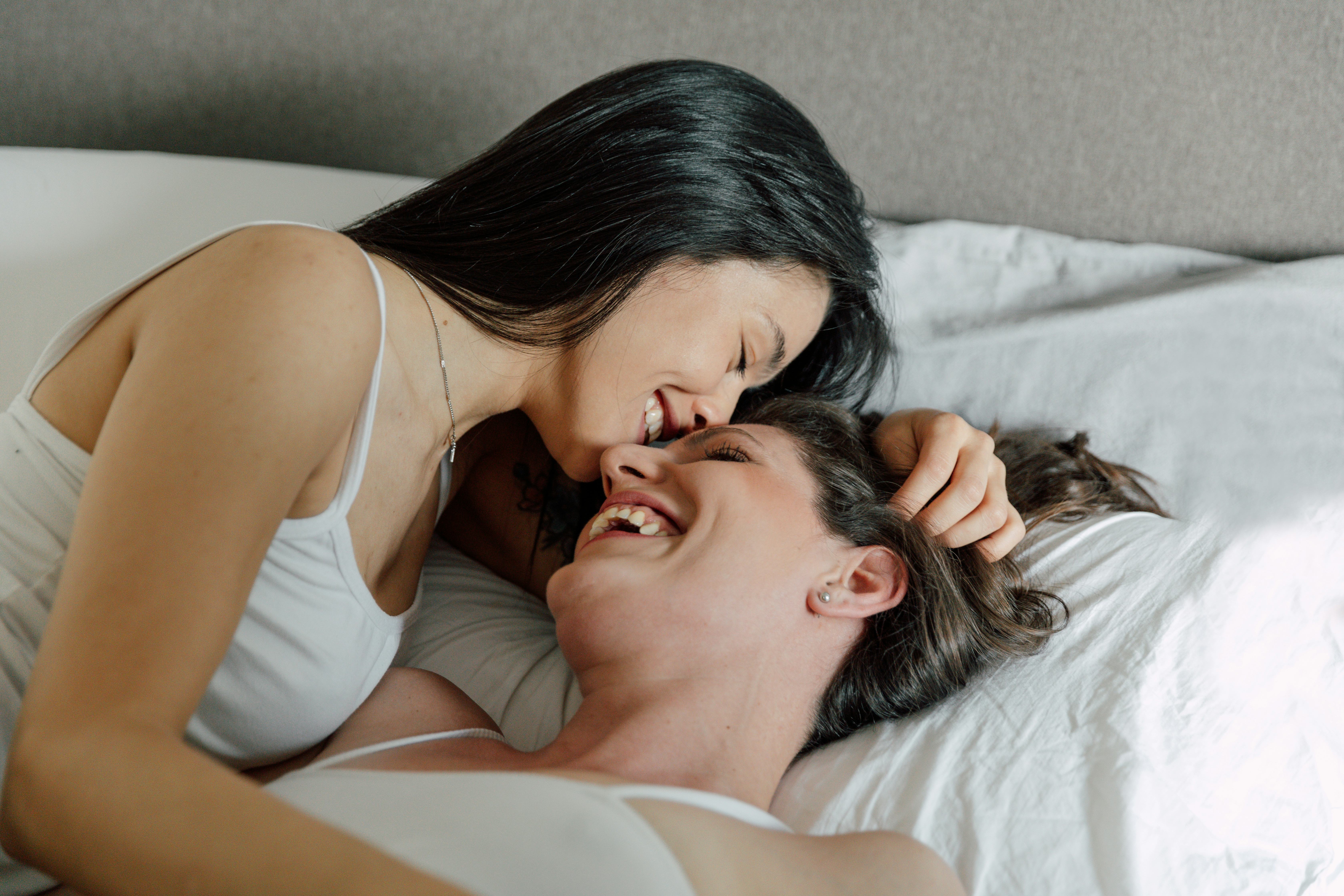 This lesbian couple is kissing in bed