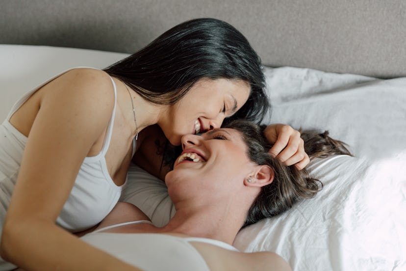 This lesbian couple is kissing in bed