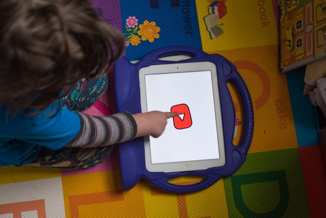 A child interacts with the YouTube Kids application on an Apple Inc. iPad tablet in an arranged phot...