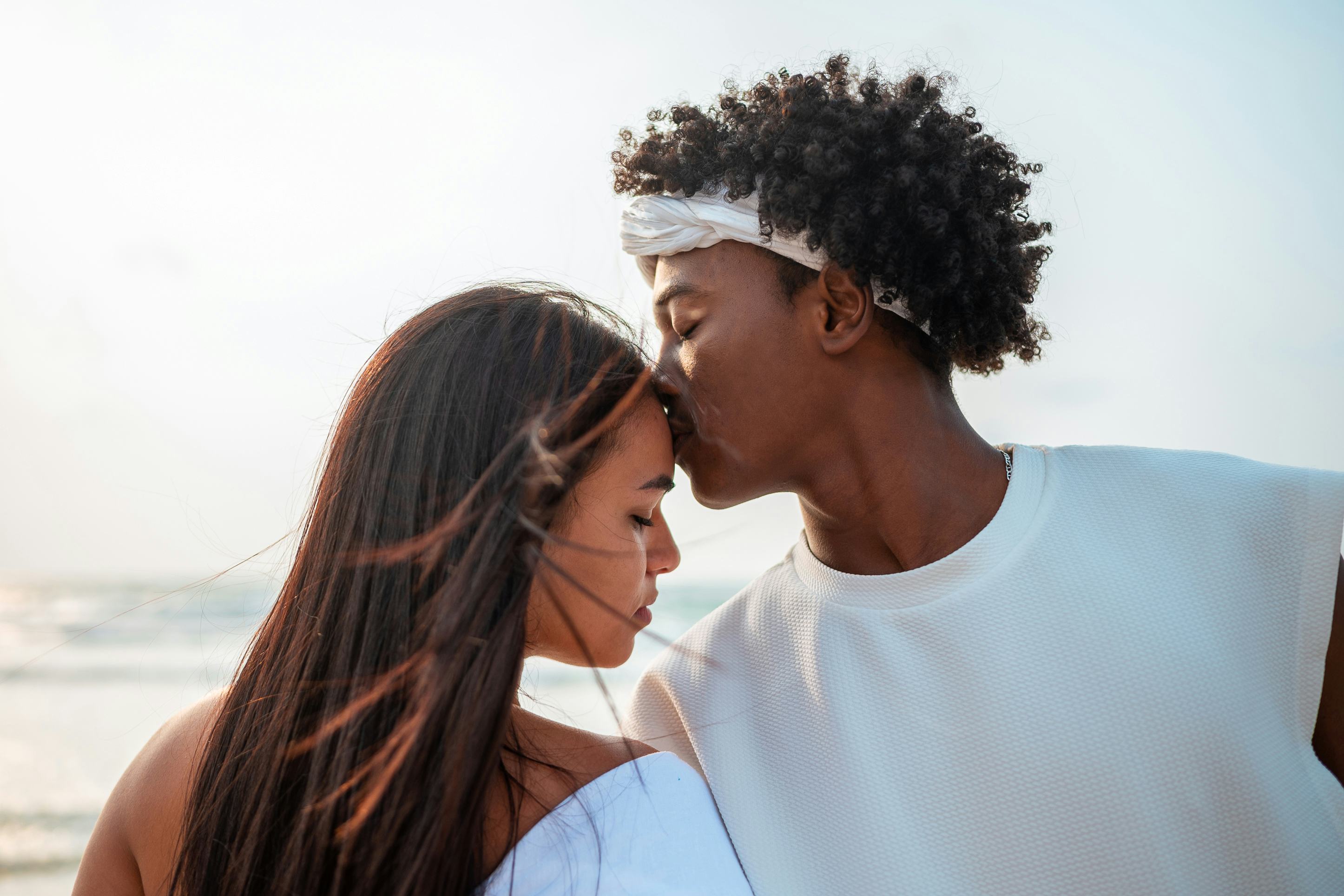 A couple kissing each other well on the beach