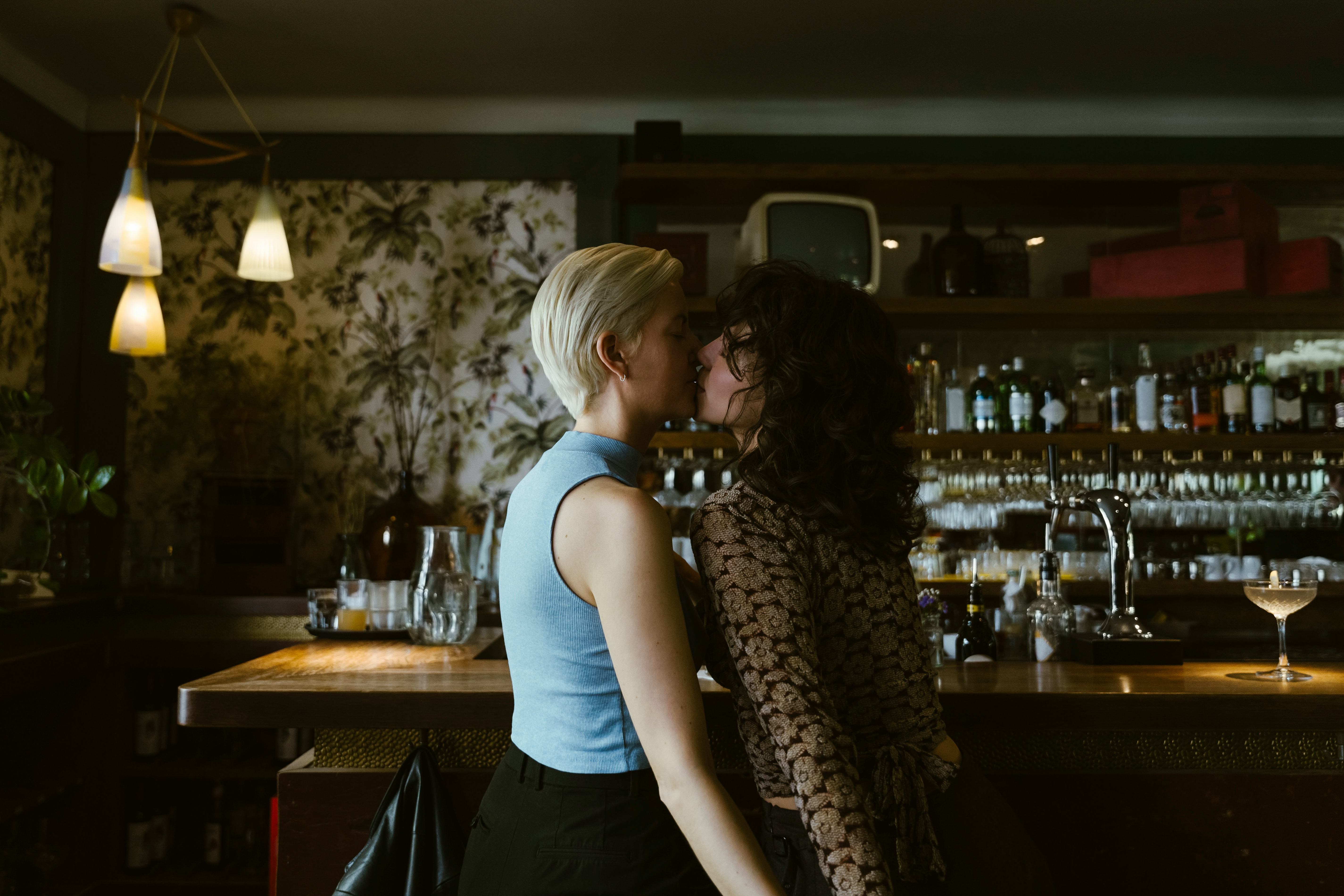 This couple is kissing in a bar