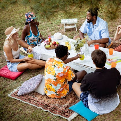 Looking down on a group of young people enjoying a colorful picnic.