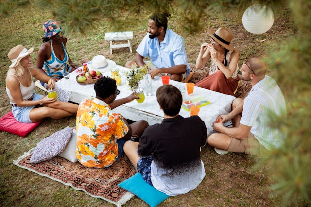 Looking down on a group of young people enjoying a colorful picnic.