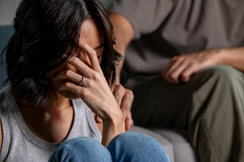 Male and female couple going through hard times in relationship problem, showing each other consolin...