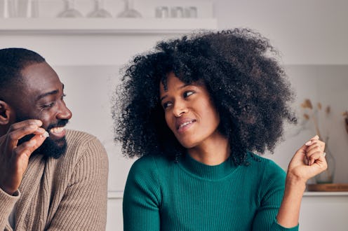 A beautiful & happy mixed-race couple, multiracial and black, enjoying a barbecue brunch made of fri...