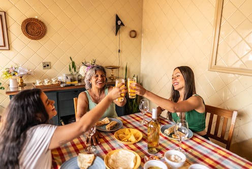 Family toasting orange juice during lunch at home