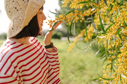Photo of a young woman proud of the plants in her garden