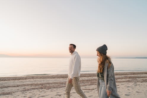 Photo of a romantic couple, having a romantic walk down the beach