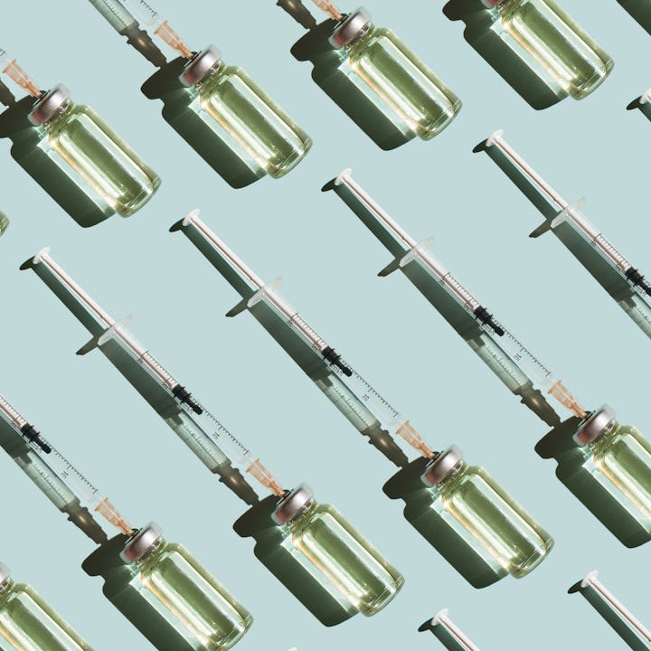 Pattern of vials and syringes with a vaccine on a blue background. Concept of medical treatment or v...