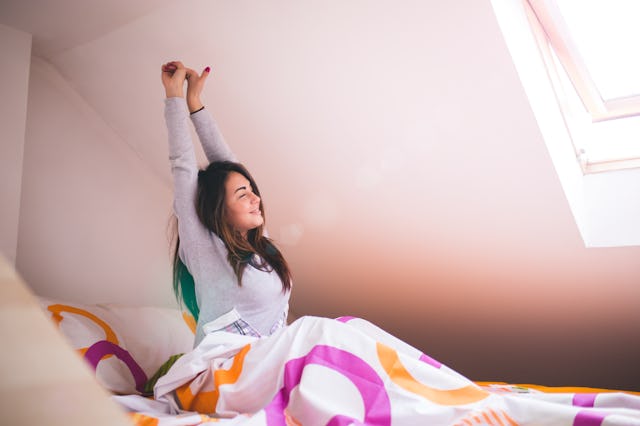 Woman stretching in bed after wake up