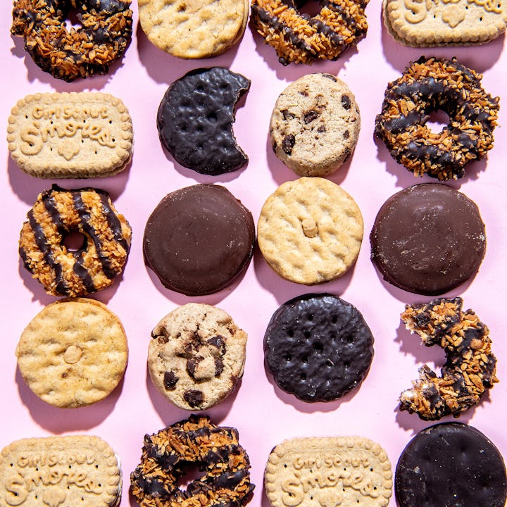 An array of Girl Scouts Cookies on a pink background.