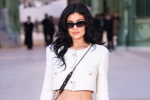 Kylie Jenner bared her navel in a crop top and leather mini.