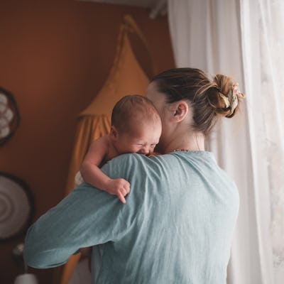 Mother with crying newborn baby. A study found that women are more likely to have their attention drawn to subliminal sad baby faces than subliminal happy ones.