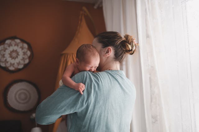 Mother with crying newborn baby. A study found that women are more likely to have their attention dr...