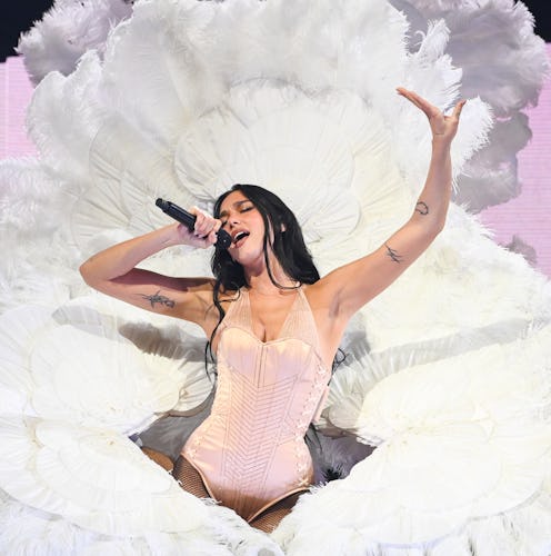 Dua Lipa wore a plunging pinstripe bra and lace-up skirt.