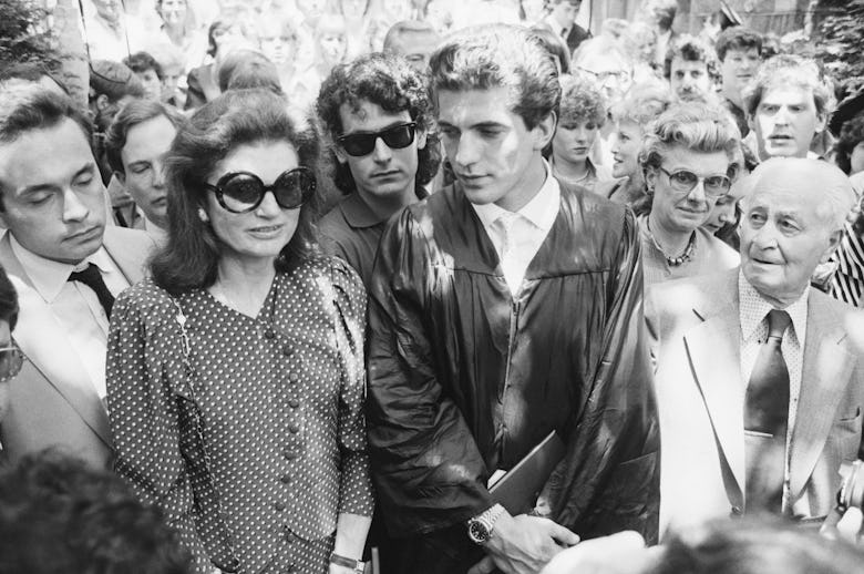John F. Kennedy Jr. looks at his mother Jacqueline Kennedy Onassis as they stand at his graduation c...