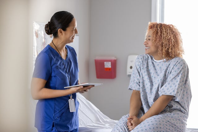 A physician gently examines and supports a young woman during a gynecological visit. At-home tests w...