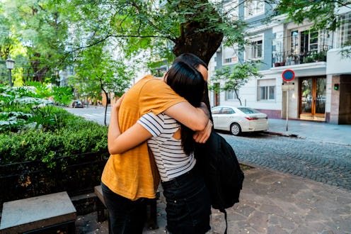 Friends embracing on the street