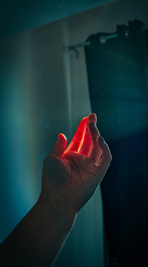 hand held up to light coming through the window