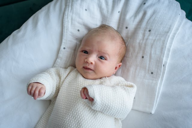 Portrait of a baby lying on pillow.