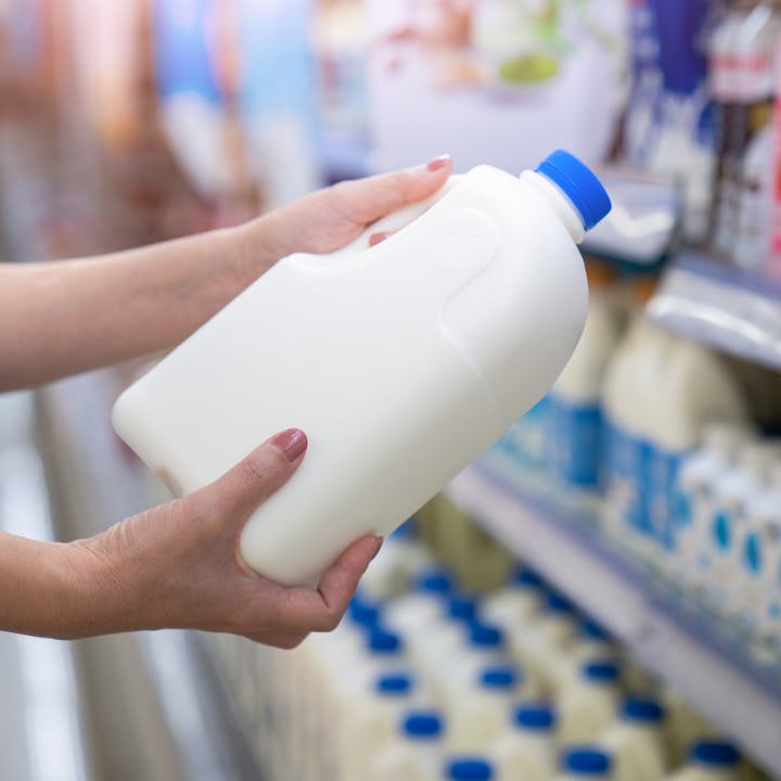 Women choose milk at a supermarket.