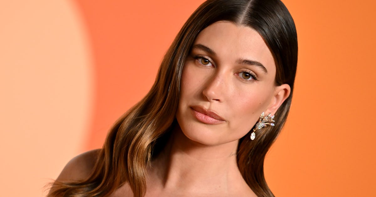 Hailey Bieber Skipped Pants & Rocked A Thong To Tease Rhode's Latest Product