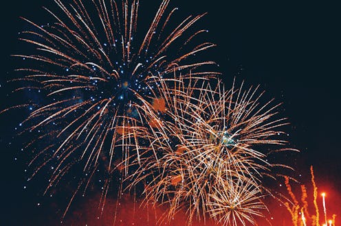 A breathtaking display of fireworks illuminating the night sky in celebration of New Year's Eve. Vib...