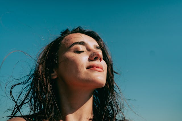 Self-portrait photo of a young woman at the beach.