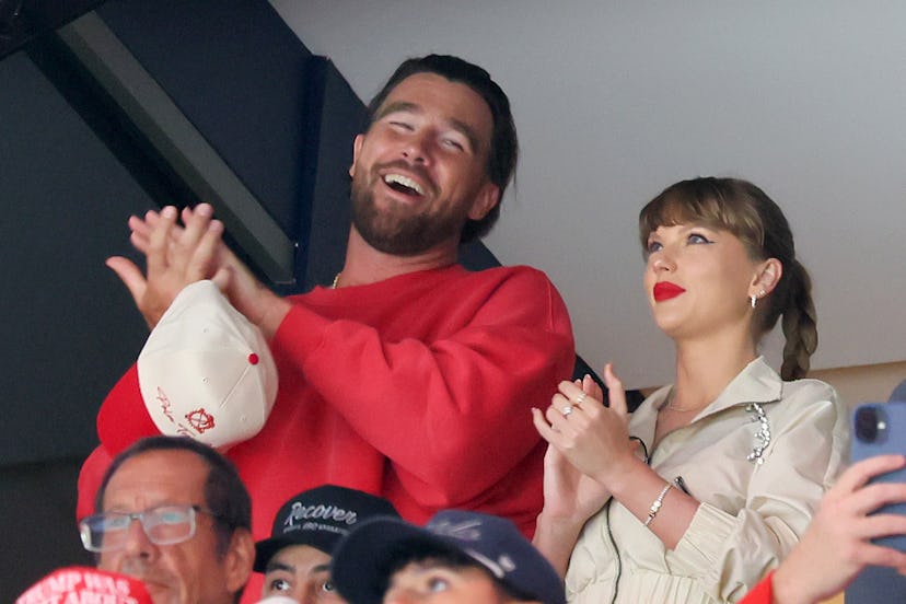 Travis Kelce, left, and Taylor Swift react as the Edmonton Oilers and the Florida Panthers play duri...
