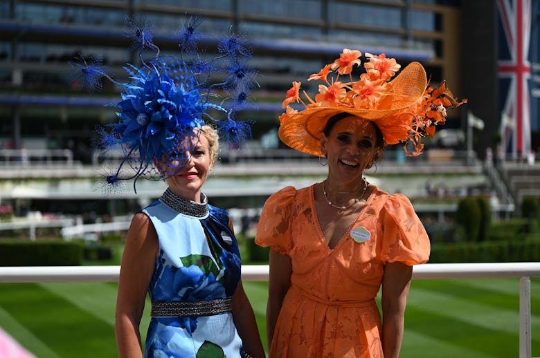 Guests, wearing colorful dresses and hats, attend the first day of the traditional Royal Ascot horse...