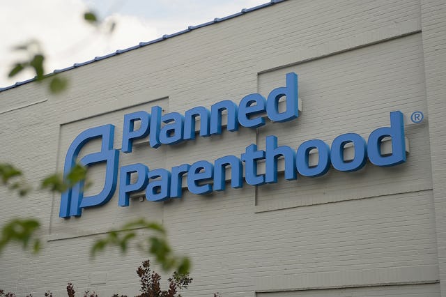 Exterior view of a building featuring a prominent blue sign that reads "Planned Parenthood," set aga...