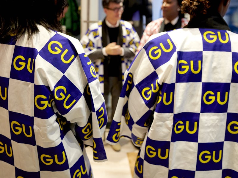 Workers wear GU shirts at the GU Co. store in the SoHo neighborhood of New York, US, on Friday, Oct....