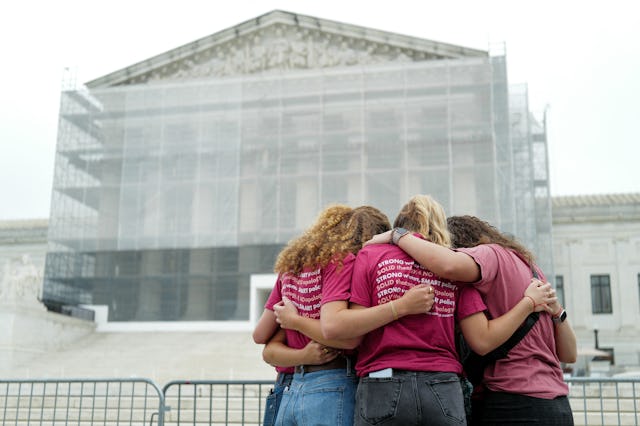 A group of women pray outside the US Supreme Court, on the final day of the Court's term, in Washing...