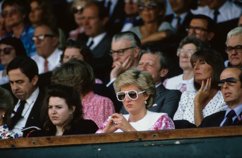 View of Diana, Princess of Wales (1961 - 1997) (fore center, in sunglasses) watches a men's tennis m...