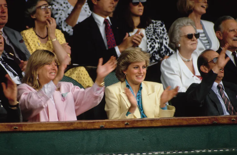 View of Diana, Princess of Wales (1961 - 1997) (fore center, in yellow jacket) as she applauds durin...