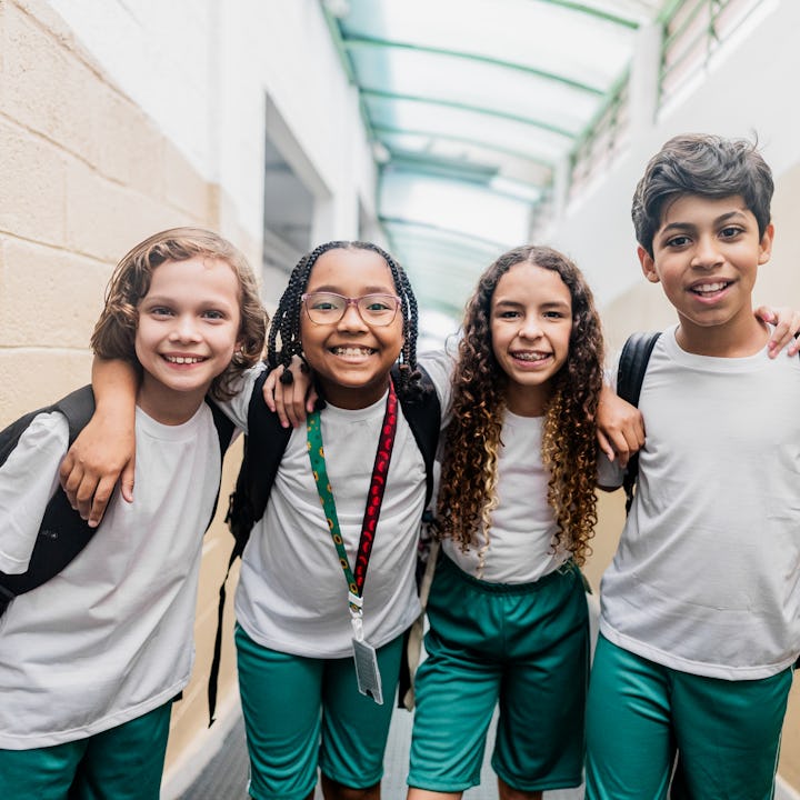 Portrait of children embracing in the school hallways