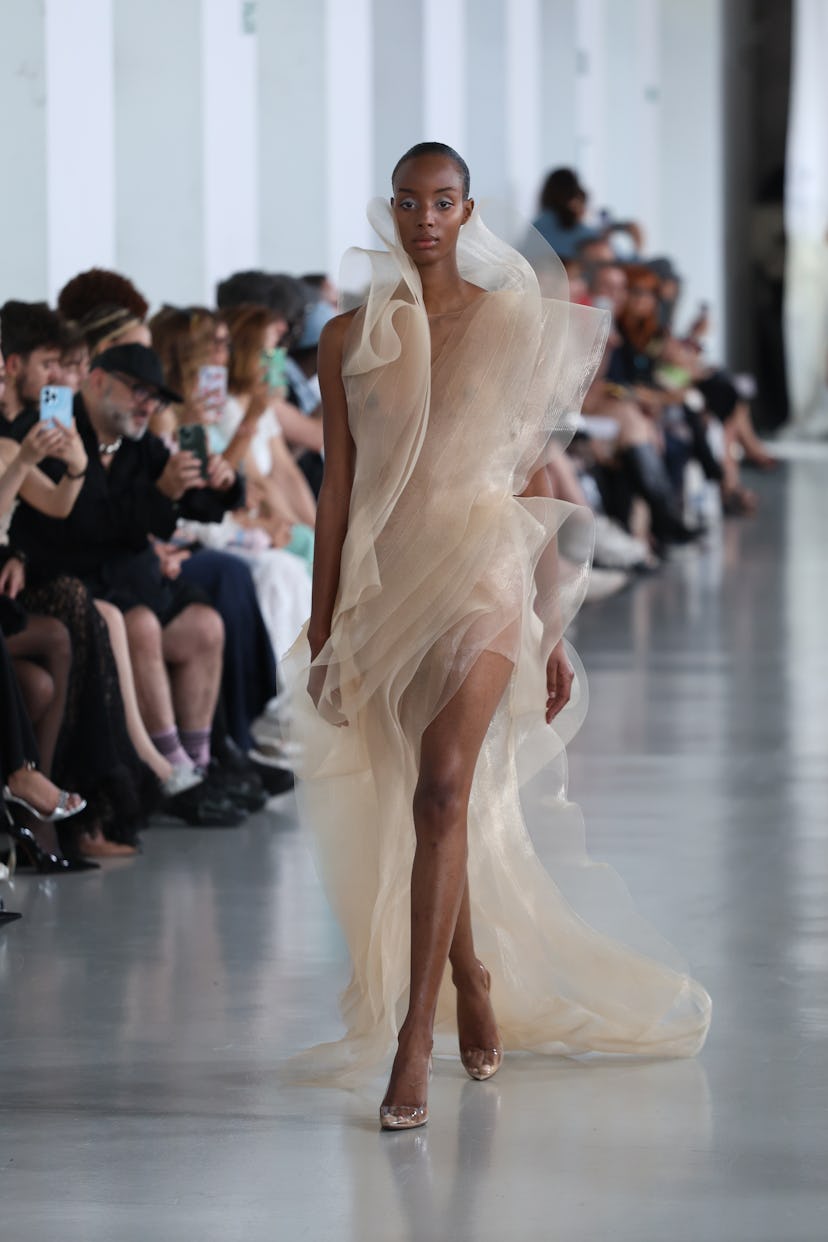 A model walks the runway during the Anatomy Of Identity By Lever Couture Haute Couture Fall/Winter 2...