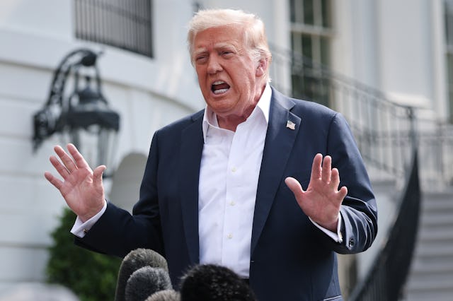 U.S. President Donald Trump answers questions while departing the White House.