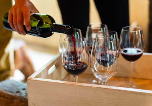Pouring Red Wine into Glasses