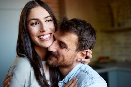 Portrait of loving couple enjoying in embrace at home.