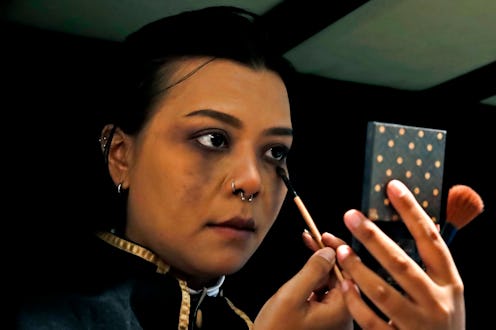 Close-Up Of Young Woman Applying Makeup During Halloween