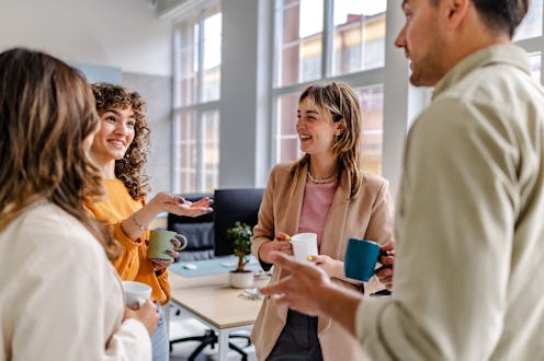 Groups of coworkers are happily engaged in conversation, sharing ideas and laughter while taking a b...